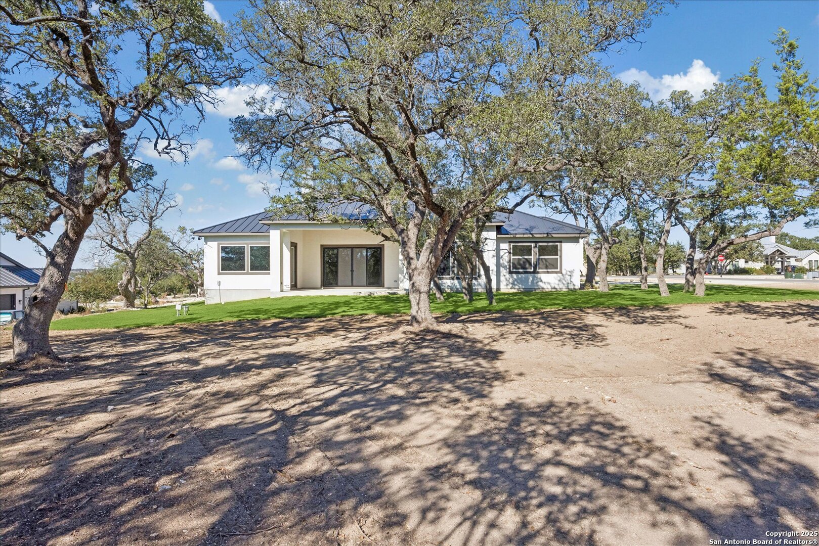 775 Maximino Ridge Bulverde, TX 78163 - Photo 40 of 41 a front view of a house with a yard and trees