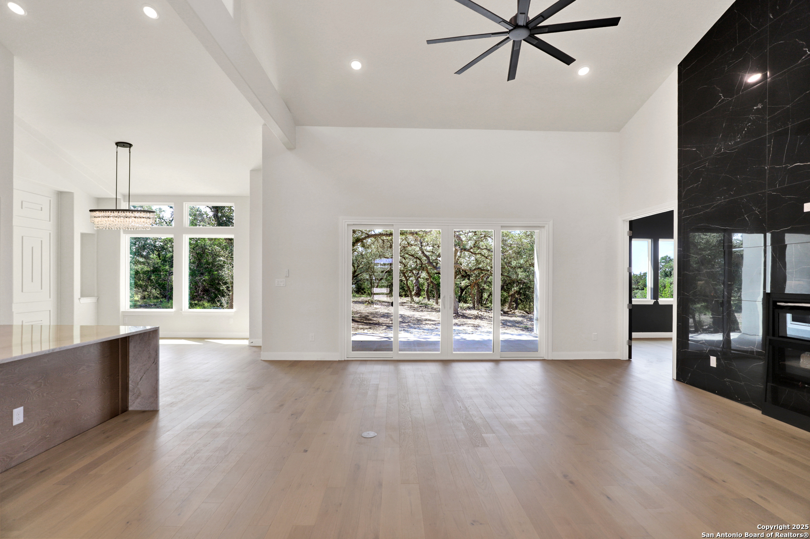 775 Maximino Ridge Bulverde, TX 78163 - Photo 9 of 41 a view of an empty room with a window and wooden floor