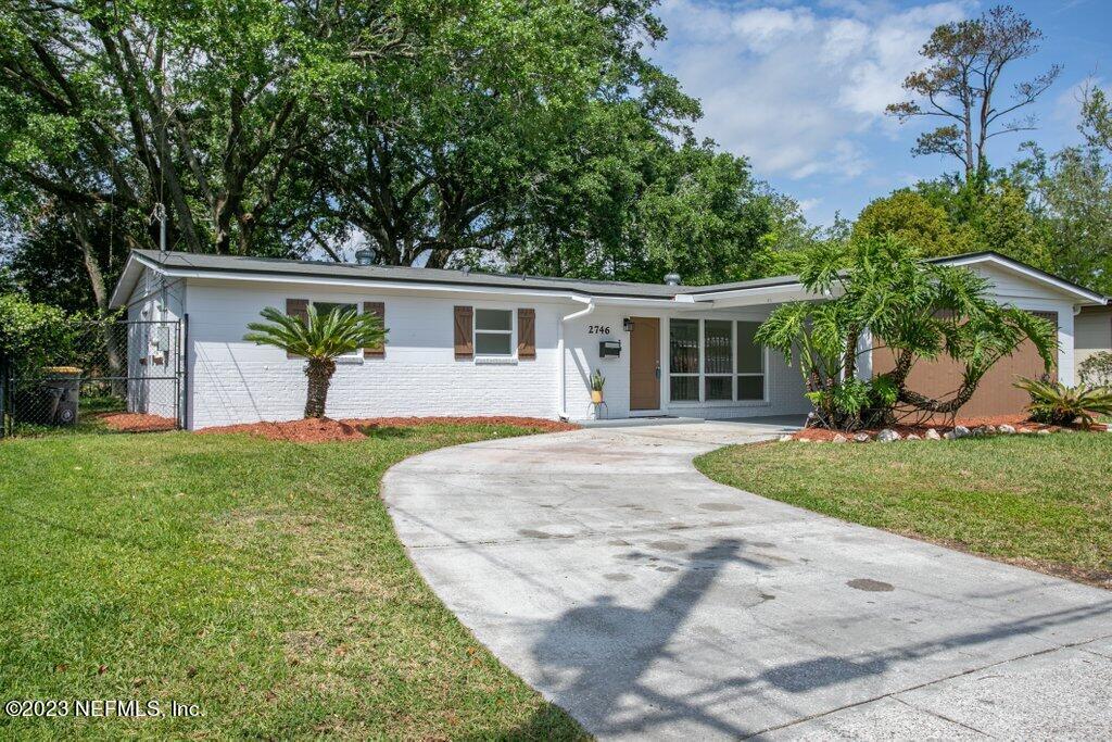 2746 Sam Road Jacksonville, FL 32216 - Photo 4 of 44 a view of a house with a yard