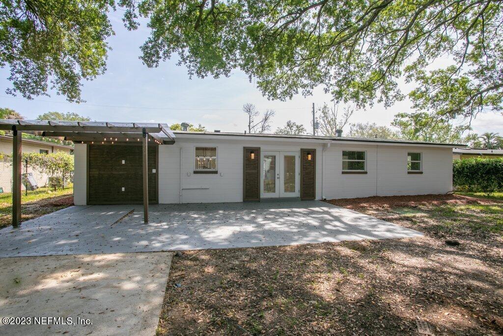 2746 Sam Road Jacksonville, FL 32216 - Photo 41 of 44 a view of a house with a yard and garage