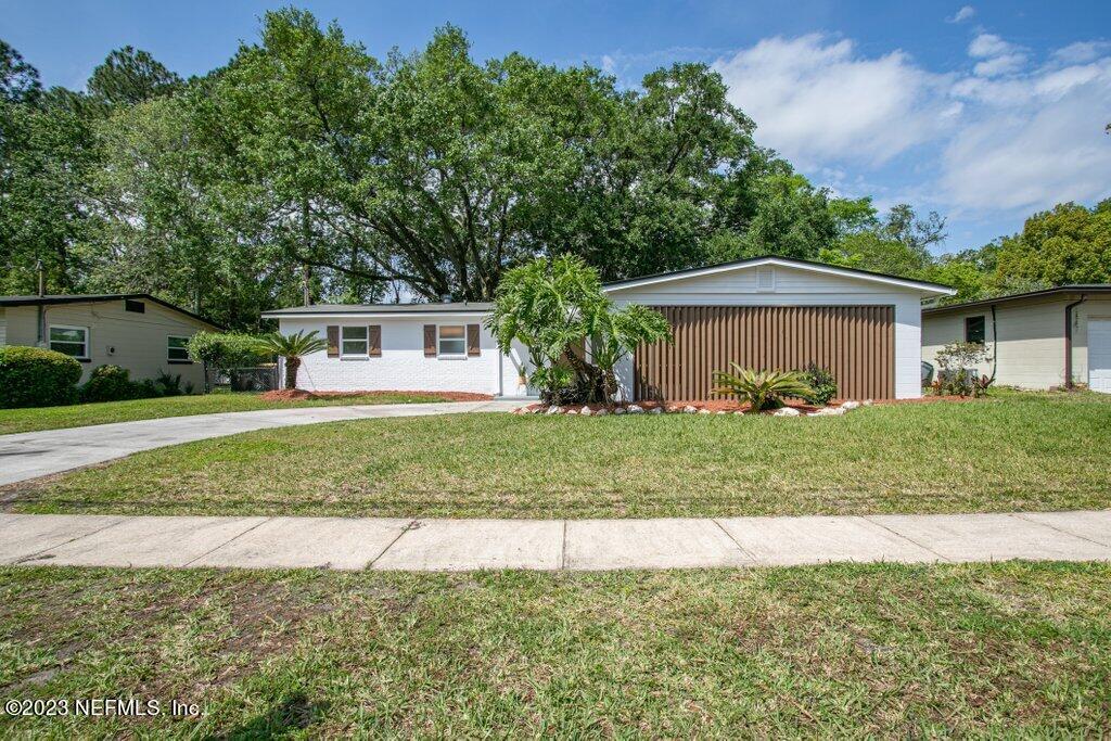 2746 Sam Road Jacksonville, FL 32216 - Photo 5 of 44 a front view of a house with a yard