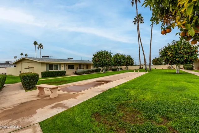 a front view of a house with a yard and potted plants