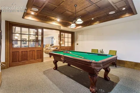 a room with pool tables and windows