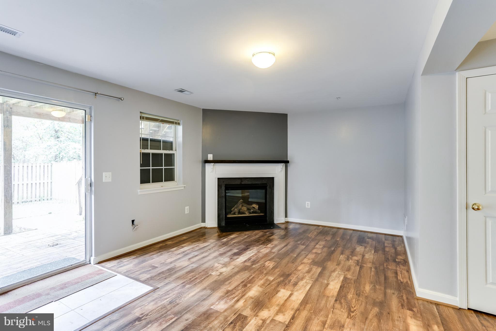 6514 Ridgeborne Drive Baltimore, MD 21237 - Photo 25 of 31 LL Family Room w/ Fireplace & Sliders to Patio