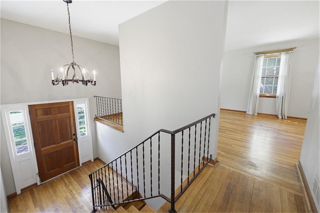 4188 Cedar Valley Lane Conley, GA 30288 - Photo 18 of 28 a view of a hallway with wooden floor and stairs