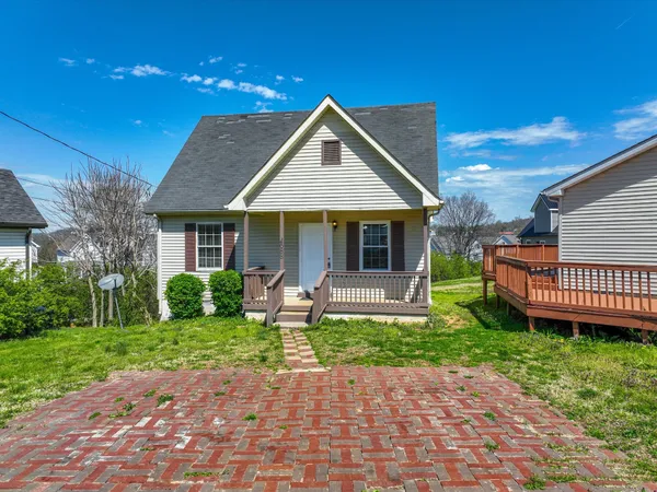 a front view of a house with a yard and porch