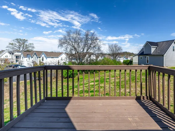 a view of a balcony with wooden floor