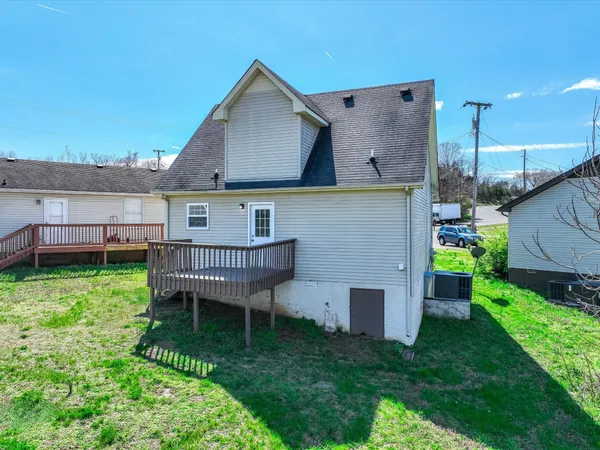 a view of a house with a yard and sitting area