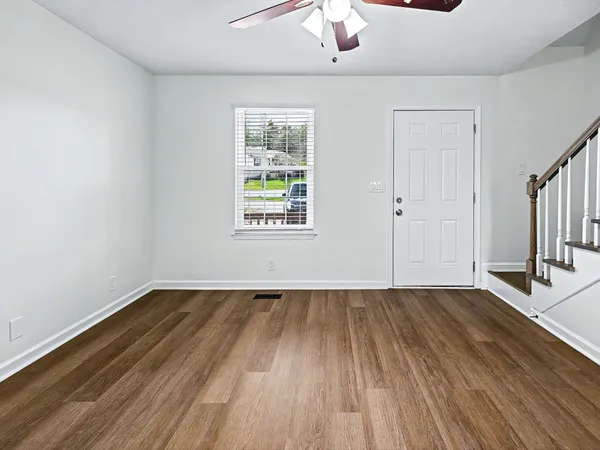 wooden floor in an empty room with a window