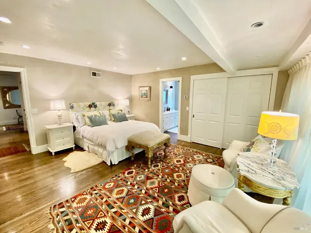 a large kitchen with kitchen island a large counter top space a sink stainless steel appliances and cabinets