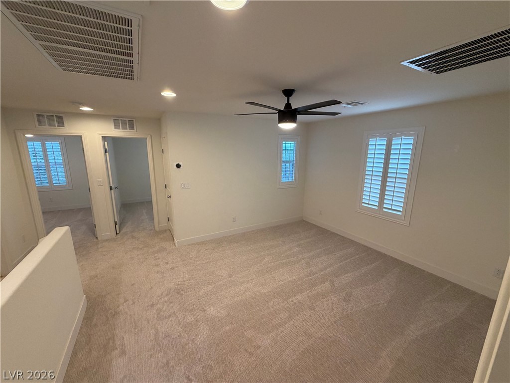 7879 Shoreline Ridge Court Las Vegas, NV 89166 - Photo 8 of 26 Plush carpeting anchors this versatile upstairs loft featuring plantation shutters and recessed lighting.