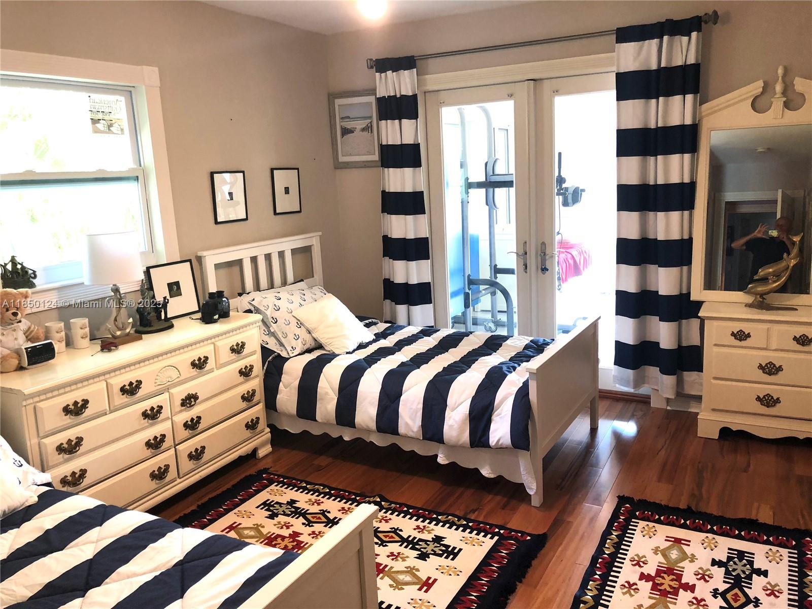 1524 Argyle Drive, Unit 1 Fort Lauderdale, FL 33312 - Photo 16 of 38 a bed sitting in a bedroom next to a window with a dresser