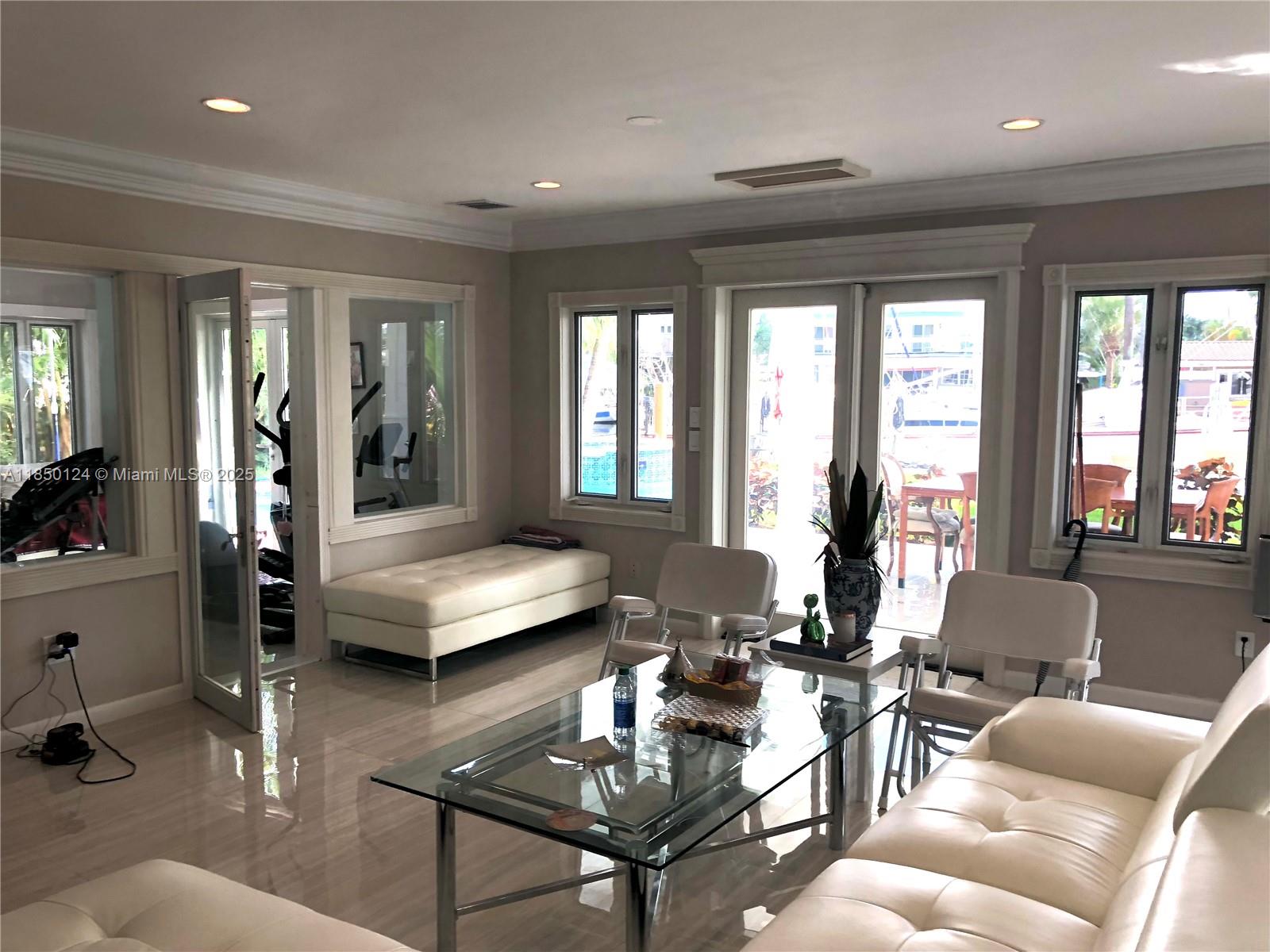 1524 Argyle Drive, Unit 1 Fort Lauderdale, FL 33312 - Photo 18 of 38 a living room with furniture and floor to ceiling windows