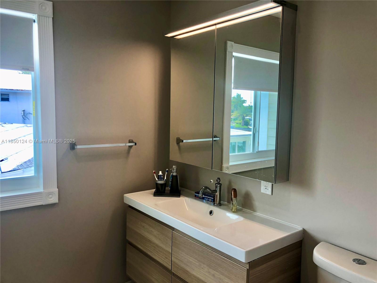 1524 Argyle Drive, Unit 1 Fort Lauderdale, FL 33312 - Photo 33 of 38 a bathroom with a sink and a mirror