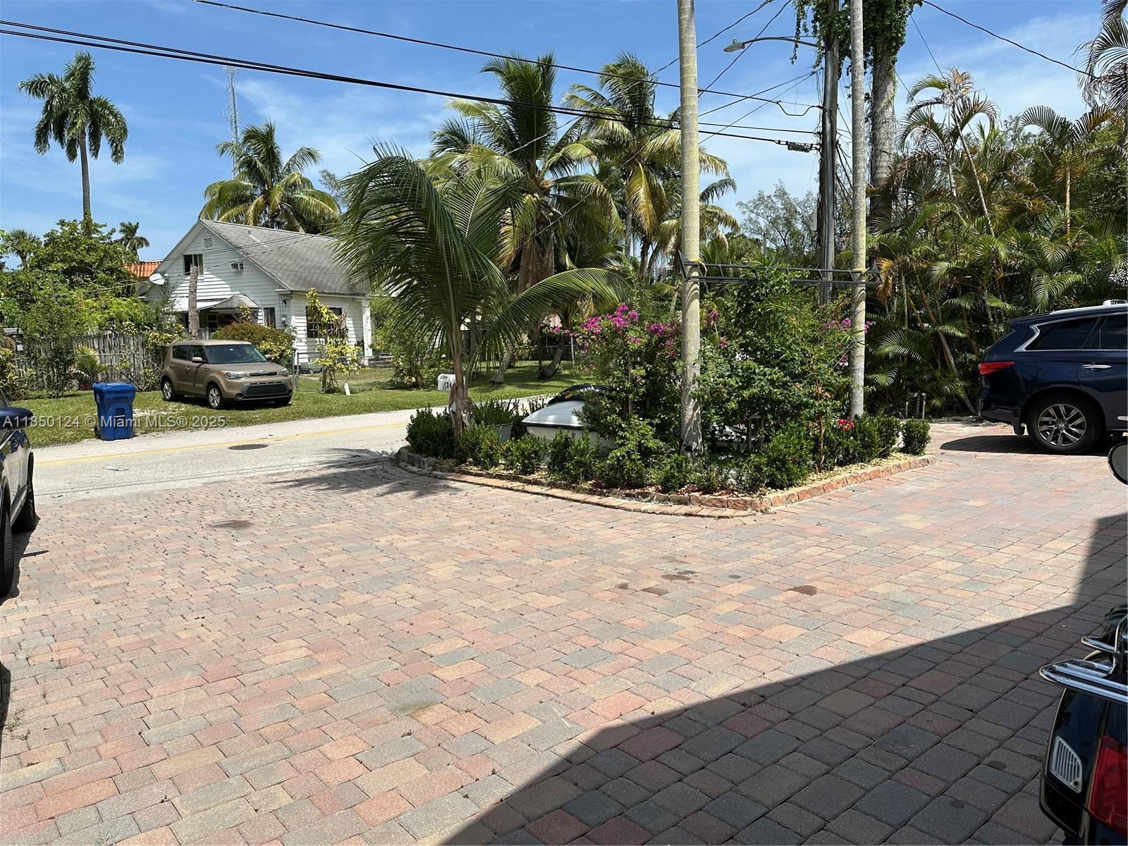 1524 Argyle Drive, Unit 1 Fort Lauderdale, FL 33312 - Photo 38 of 38 a view of a white house with a yard and sitting area