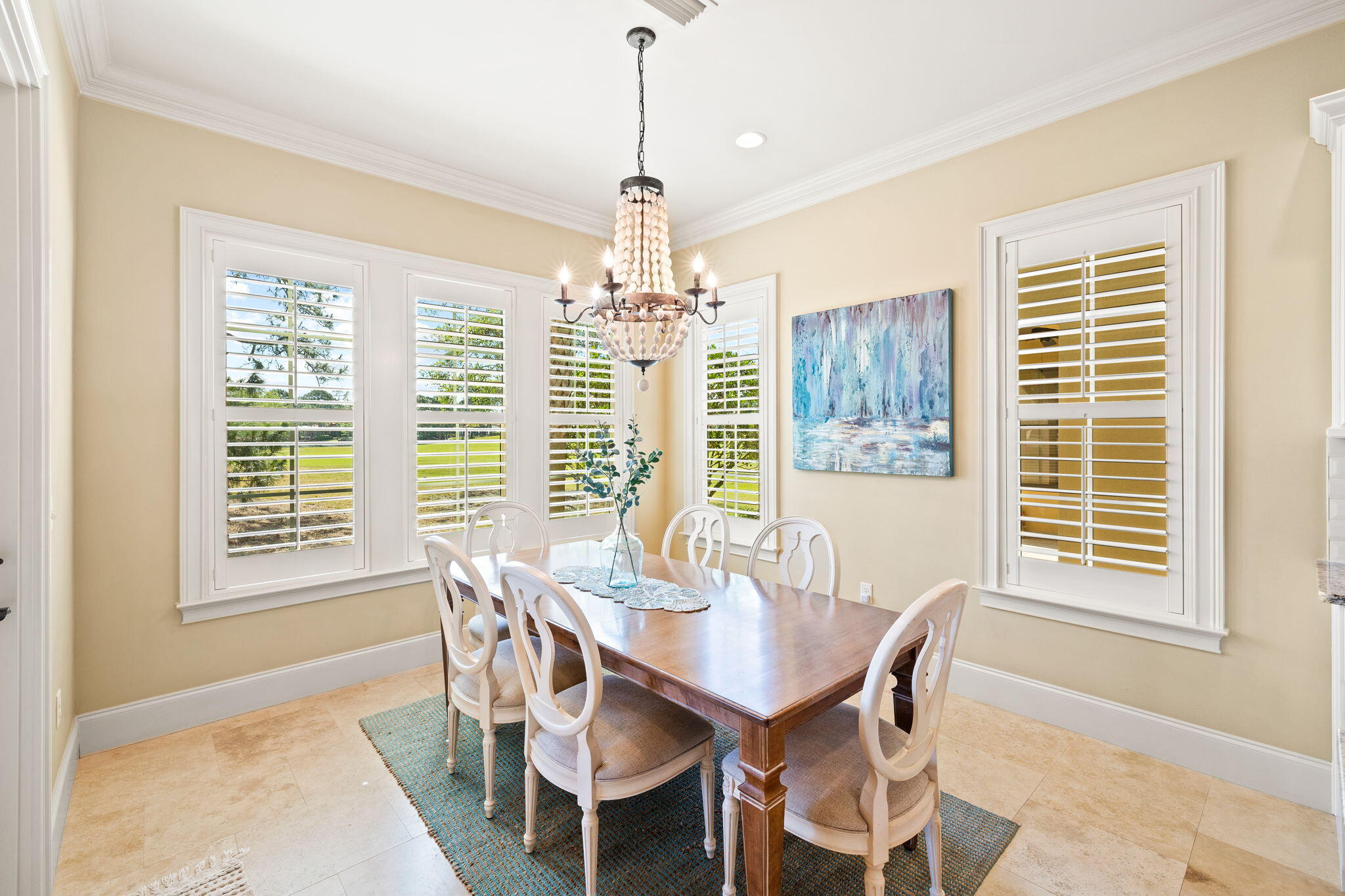 1897 Baytowne Loop Miramar Beach, FL 32550 - Photo 23 of 68 a dining room with wooden floor a chandelier a wooden table and chairs