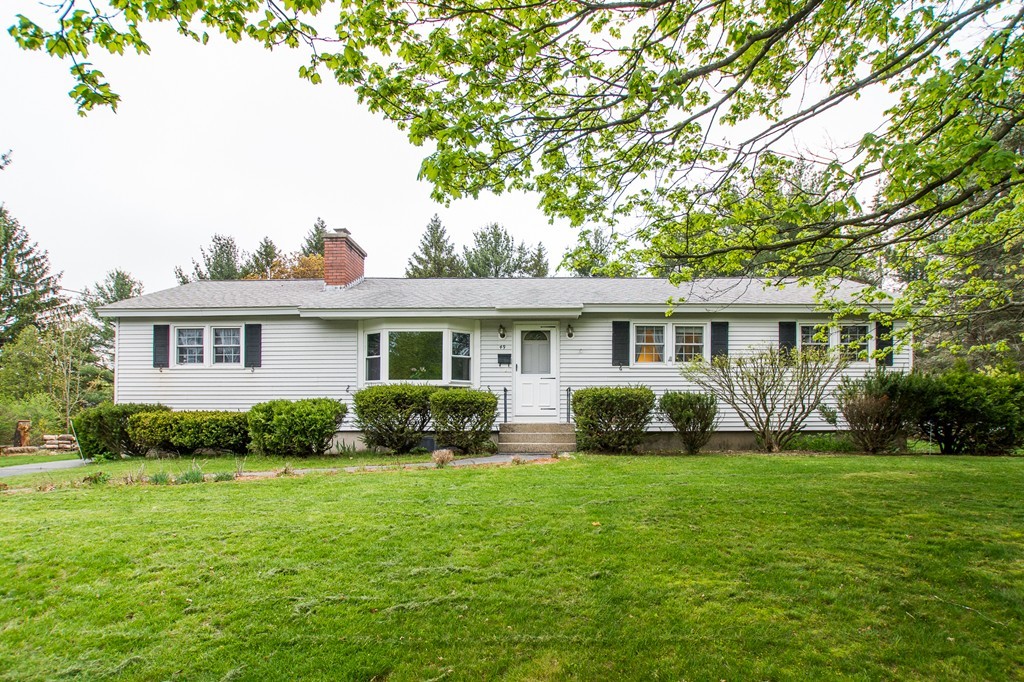 49 Ansie Road Chelmsford, MA 01824 - Photo 1 of 22 a front view of a house with a yard and outdoor seating