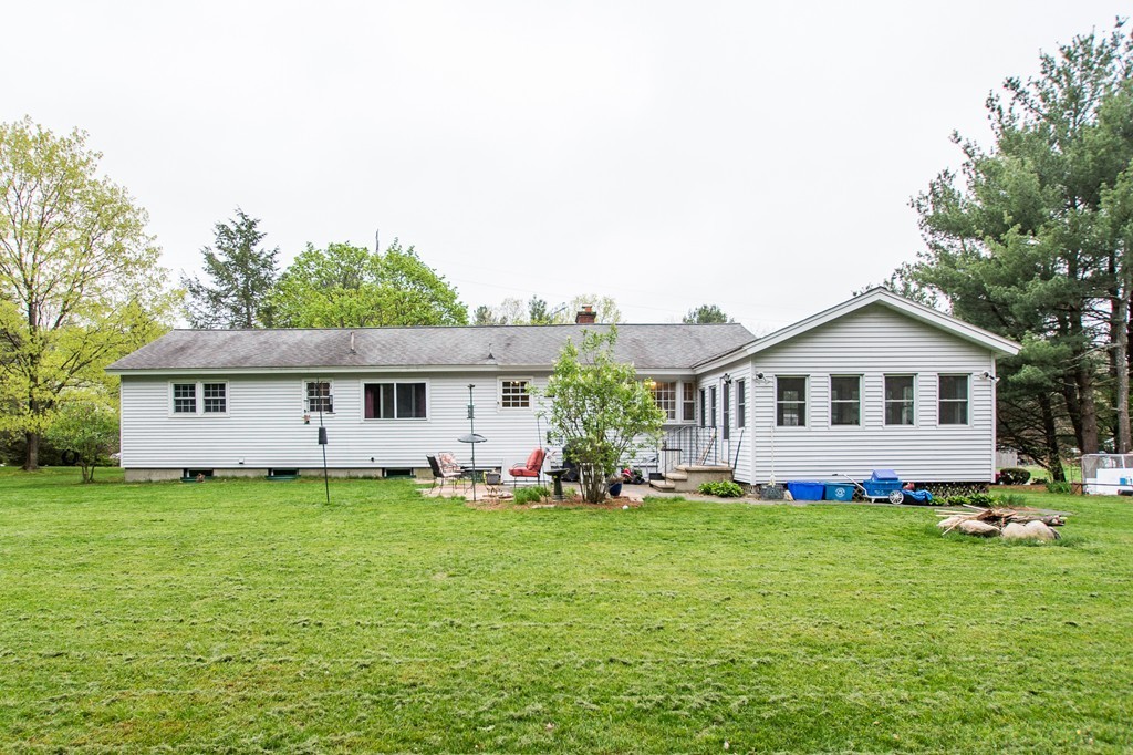 49 Ansie Road Chelmsford, MA 01824 - Photo 19 of 22 a front view of a house with a yard and trees