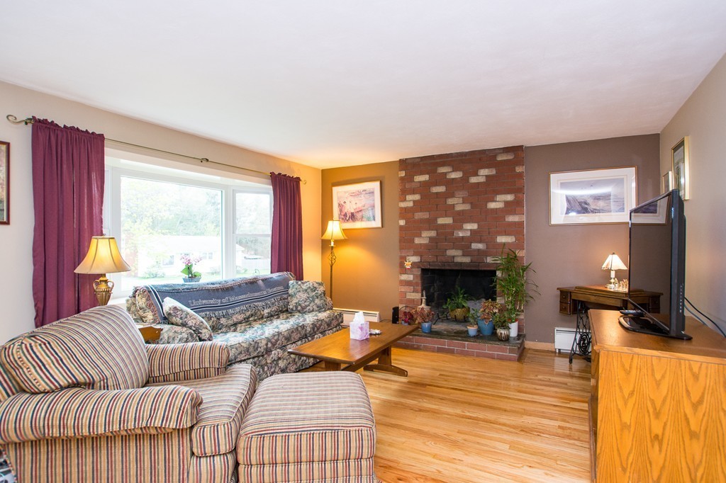 49 Ansie Road Chelmsford, MA 01824 - Photo 3 of 22 a living room with furniture and a fireplace
