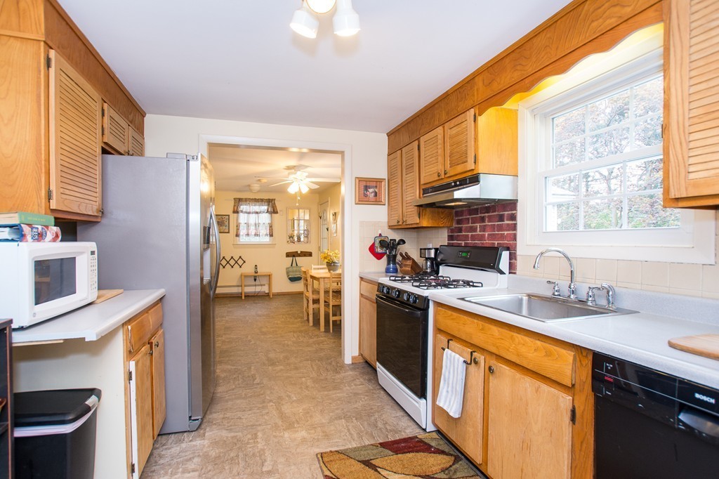 49 Ansie Road Chelmsford, MA 01824 - Photo 5 of 22 a kitchen with stainless steel appliances granite countertop sink stove top oven and cabinets