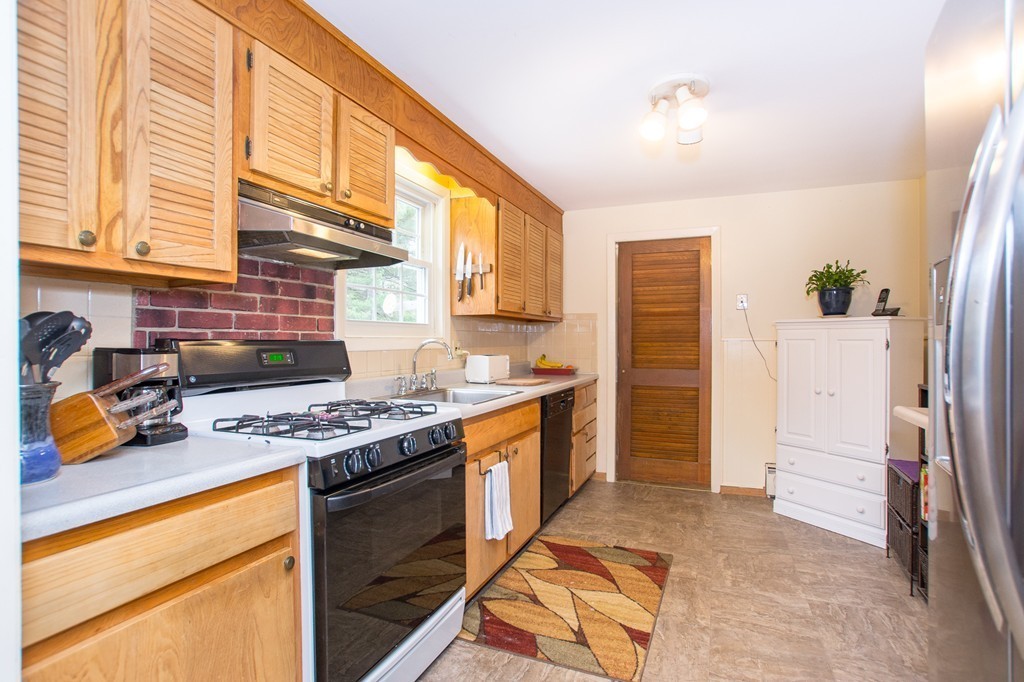 49 Ansie Road Chelmsford, MA 01824 - Photo 6 of 22 a kitchen with stainless steel appliances granite countertop a stove a sink and a refrigerator