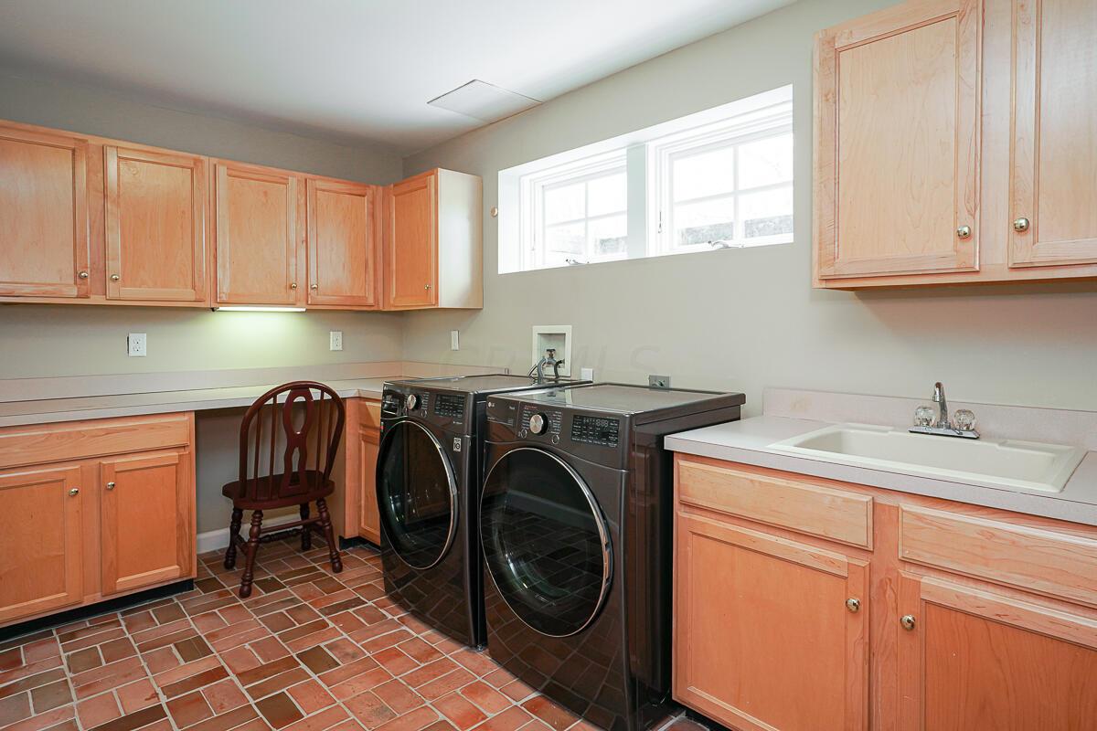 3750 Alward Road Southwest Pataskala, OH 43062 - Photo 31 of 60 With an abundance of cabinetry, washer/dryer and sink.