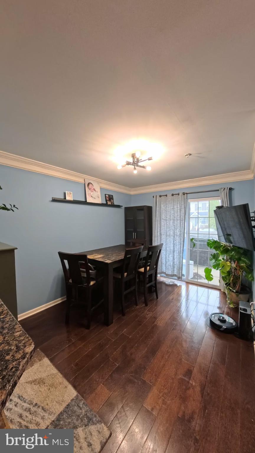 219 Flagstone Road, Unit 6 Chester Springs, PA 19425 - Photo 3 of 15 a living room with furniture and a flat screen tv with kitchen view