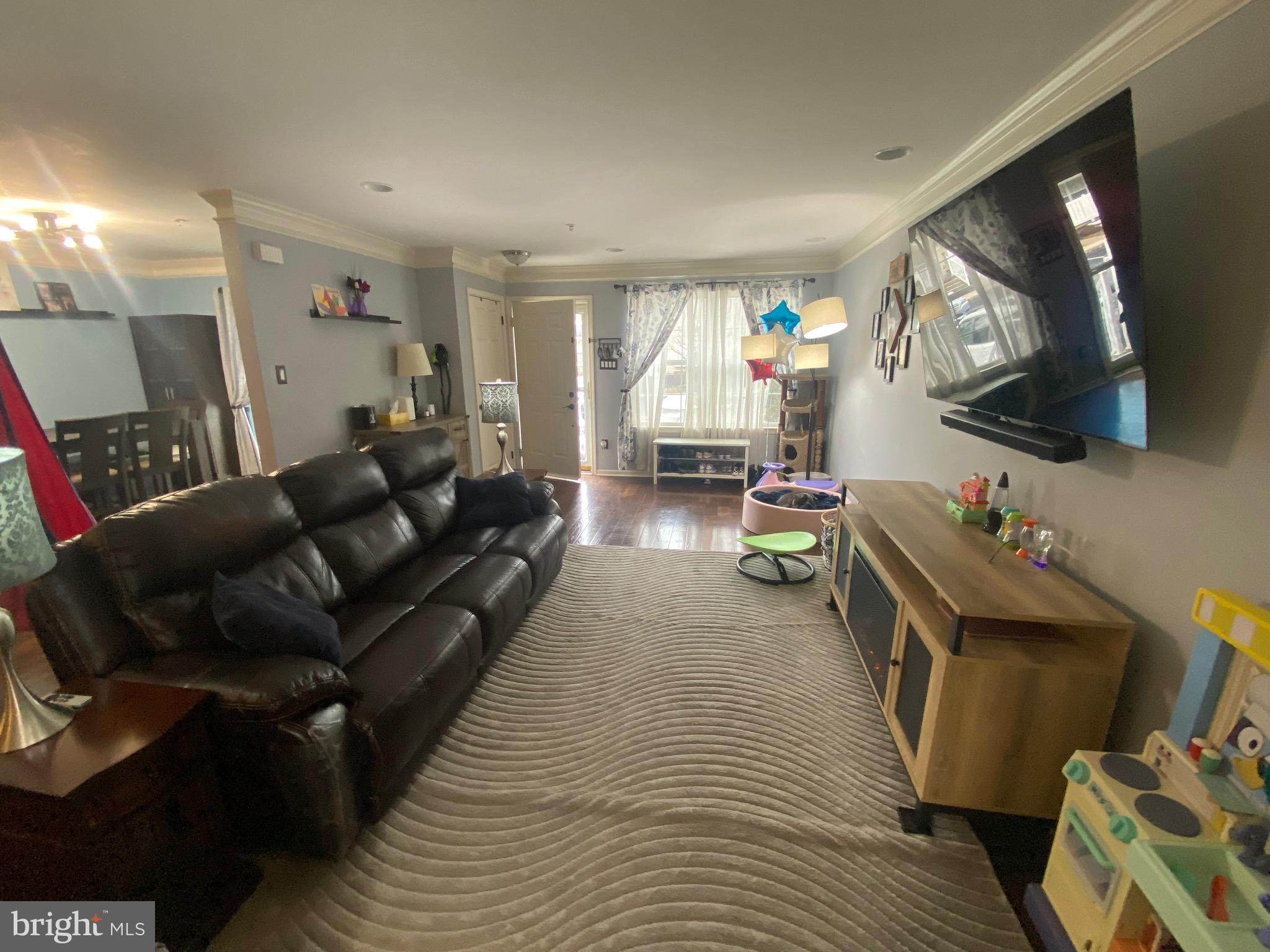 219 Flagstone Road, Unit 6 Chester Springs, PA 19425 - Photo 4 of 15 a living room with furniture and a flat screen tv