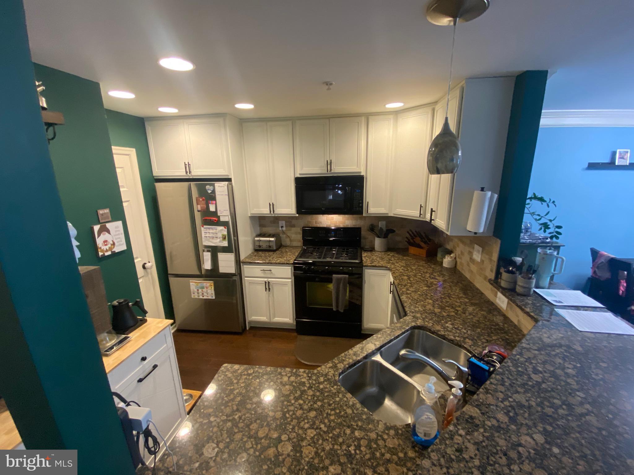 219 Flagstone Road, Unit 6 Chester Springs, PA 19425 - Photo 8 of 15 a kitchen with sink refrigerator and microwave