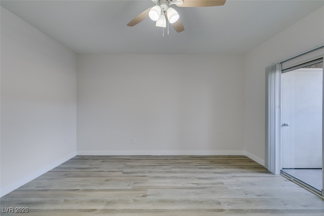 5525 West Flamingo Road, Unit 1028 Las Vegas, NV 89103 - Photo 12 of 42 Unfurnished room with light wood-style floors and ceiling fan