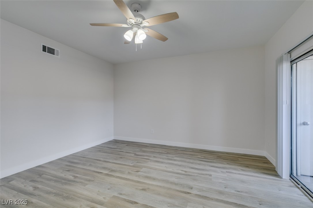5525 West Flamingo Road, Unit 1028 Las Vegas, NV 89103 - Photo 13 of 42 Unfurnished room with light wood finished floors and a ceiling fan