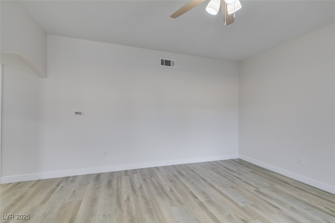 5525 West Flamingo Road, Unit 1028 Las Vegas, NV 89103 - Photo 14 of 42 Unfurnished room with light wood-style floors and a ceiling fan