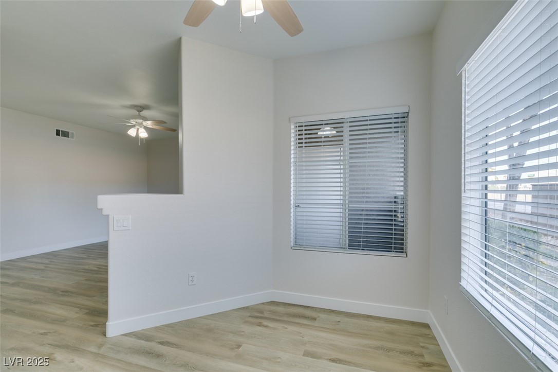 5525 West Flamingo Road, Unit 1028 Las Vegas, NV 89103 - Photo 26 of 42 Unfurnished room with healthy amount of natural light, light wood-style floors, and a ceiling fan