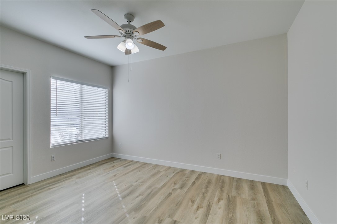 5525 West Flamingo Road, Unit 1028 Las Vegas, NV 89103 - Photo 38 of 42 Empty room featuring light wood-style flooring and ceiling fan