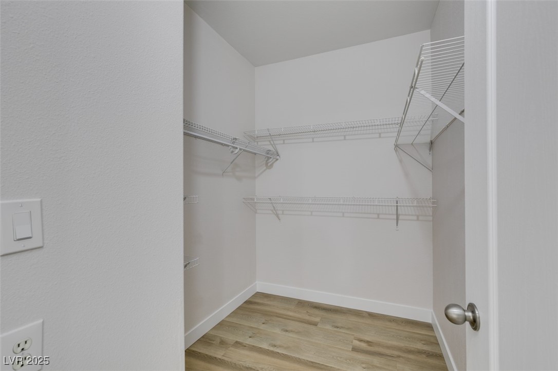 5525 West Flamingo Road, Unit 1028 Las Vegas, NV 89103 - Photo 40 of 42 Walk in closet with light wood-style floors