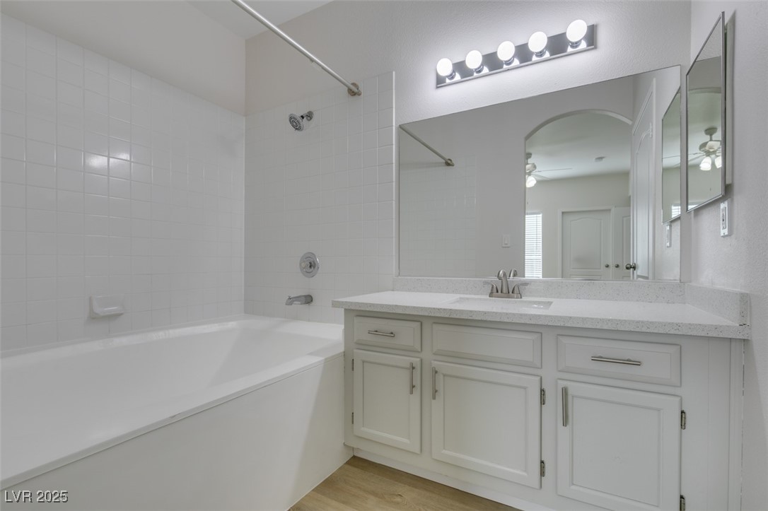 5525 West Flamingo Road, Unit 1028 Las Vegas, NV 89103 - Photo 41 of 42 Full bathroom featuring vanity, bathing tub / shower combination, a ceiling fan, and light wood-style floors