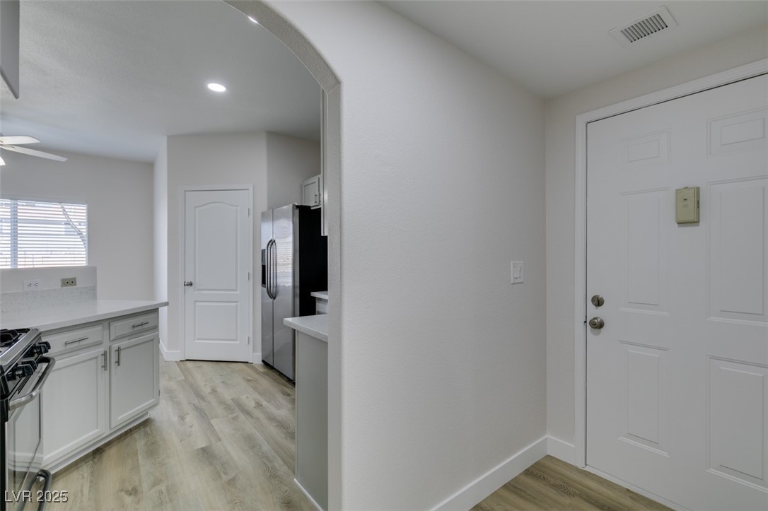 5525 West Flamingo Road, Unit 1028 Las Vegas, NV 89103 - Photo 7 of 42 Entryway featuring arched walkways, light wood finished floors, a ceiling fan, and recessed lighting