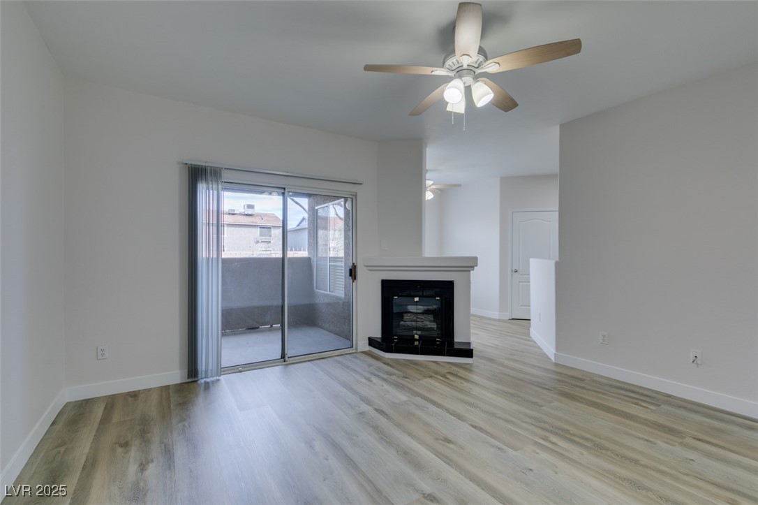 5525 West Flamingo Road, Unit 1028 Las Vegas, NV 89103 - Photo 10 of 42 Unfurnished living room with light wood-style flooring and ceiling fan