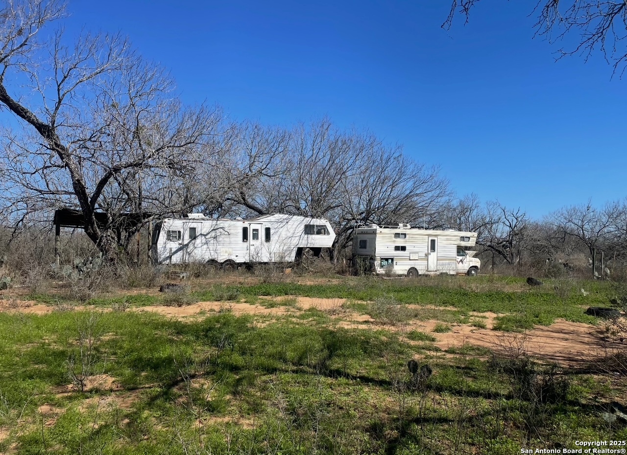5440 Tabberer Road Poteet, TX 78065 - Photo 10 of 10 a front view of residential houses with yard and trees