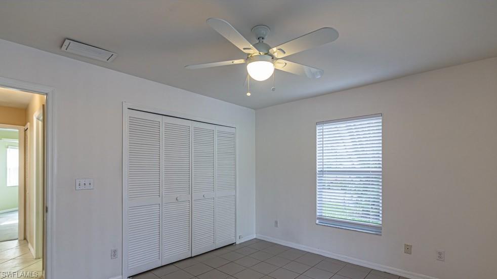1620 Forest Lakes Boulevard Naples, FL 34105 - Photo 12 of 27 a view of an empty room with window and chandelier fan