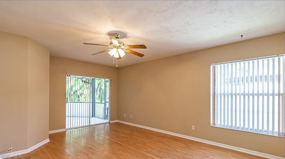 1620 Forest Lakes Boulevard Naples, FL 34105 - Photo 17 of 27 an empty room with wooden floor and windows