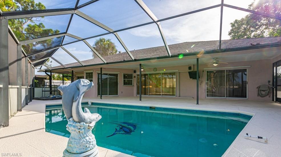 1620 Forest Lakes Boulevard Naples, FL 34105 - Photo 23 of 27 a front view of a house with garden and outdoor seating