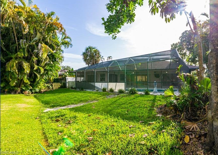 1620 Forest Lakes Boulevard Naples, FL 34105 - Photo 26 of 27 a view of an house with backyard space and garden