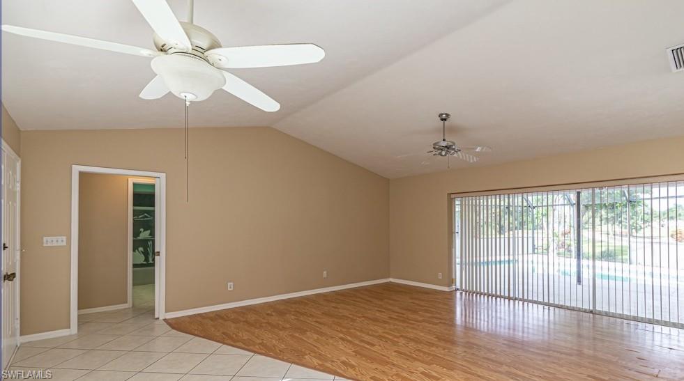 1620 Forest Lakes Boulevard Naples, FL 34105 - Photo 5 of 27 wooden floor in an empty room with a window