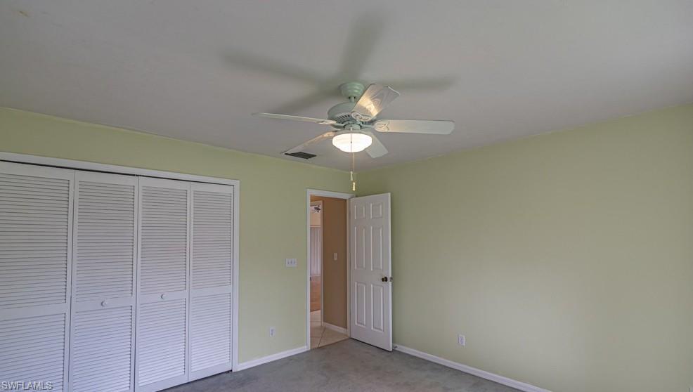 1620 Forest Lakes Boulevard Naples, FL 34105 - Photo 9 of 27 a view of a chandelier fan and closet