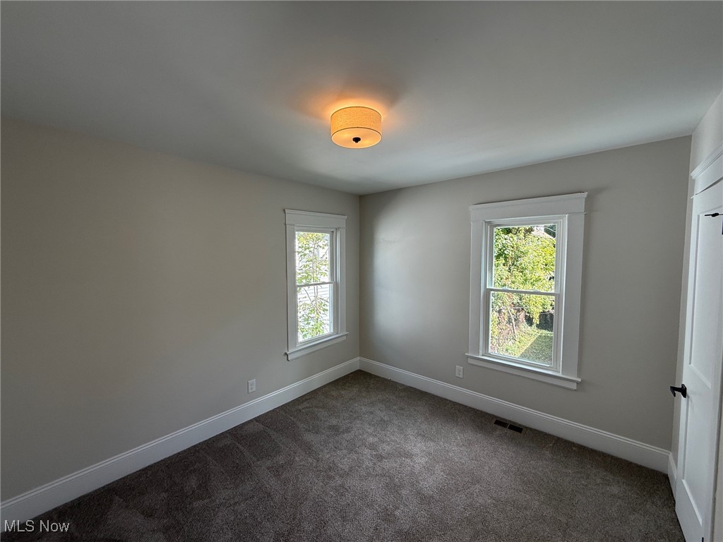 2185 Rexwood Road Cleveland, OH 44118 - Photo 14 of 26 Spare room featuring dark carpet and baseboards