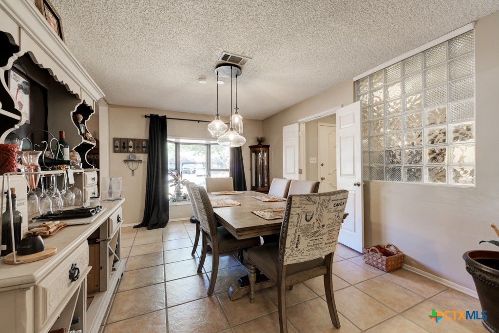 1229 Rapids Road New Braunfels, TX 78130 - Photo 8 of 27 a view of a dining room with furniture window and outside view