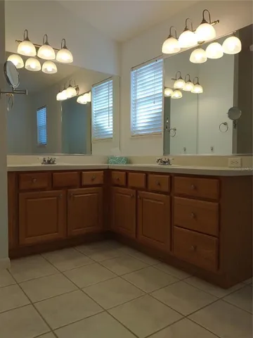 a bathroom with a granite countertop sink mirror and toilet