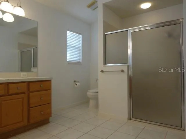 a bathroom with a shower and a toilet