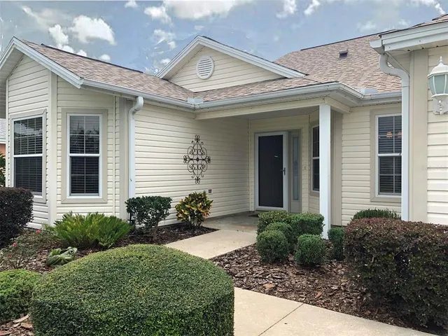 a view of a house with potted plants